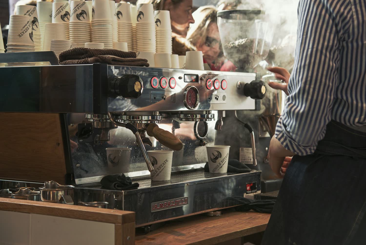 Barista pulling a shot on the espresso machine