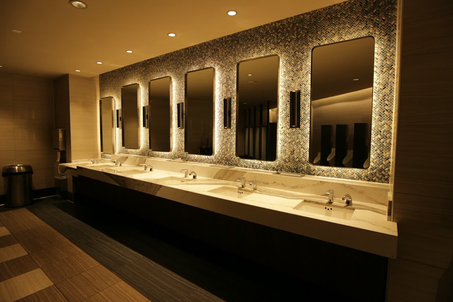 Washroom with backlit mirrors