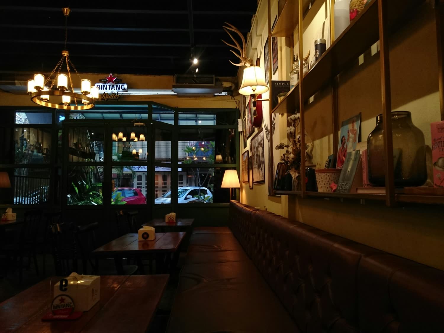 The dining room at Salt & Iron in the evening, lit by low hanging lamps