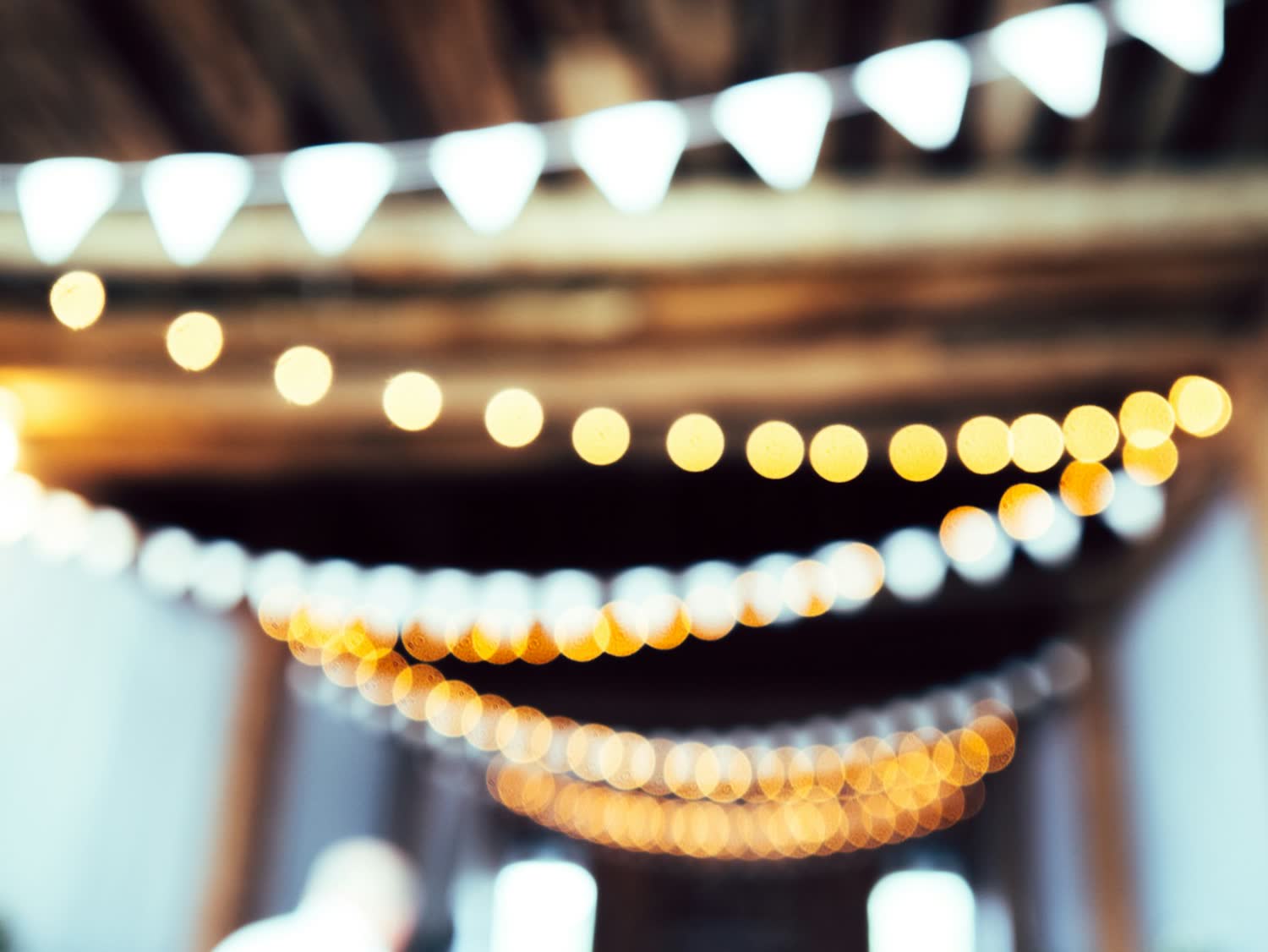 Festoon lights strung above the courtyard at dusk