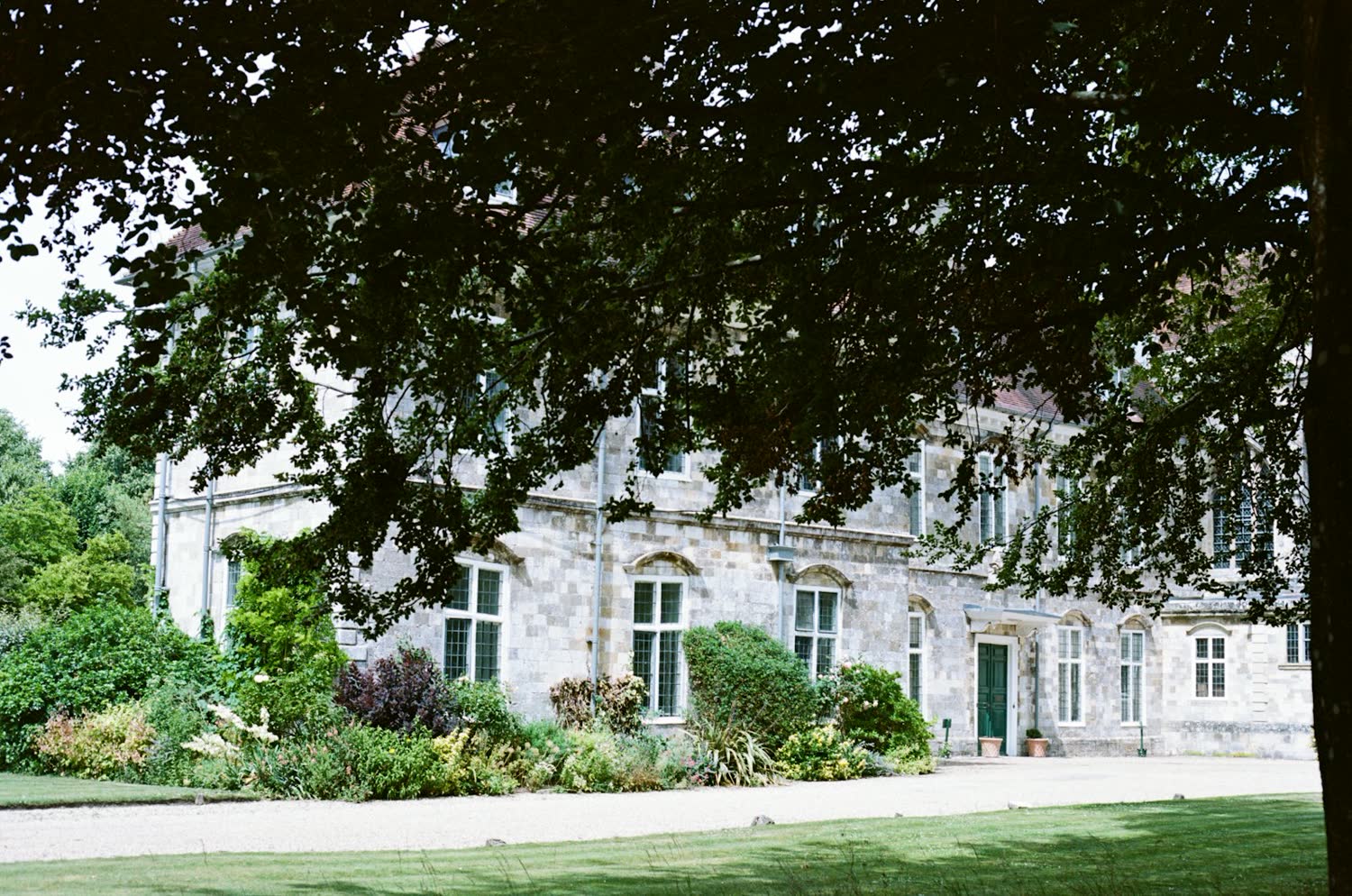Hartwell House seen across the lawn through mature trees